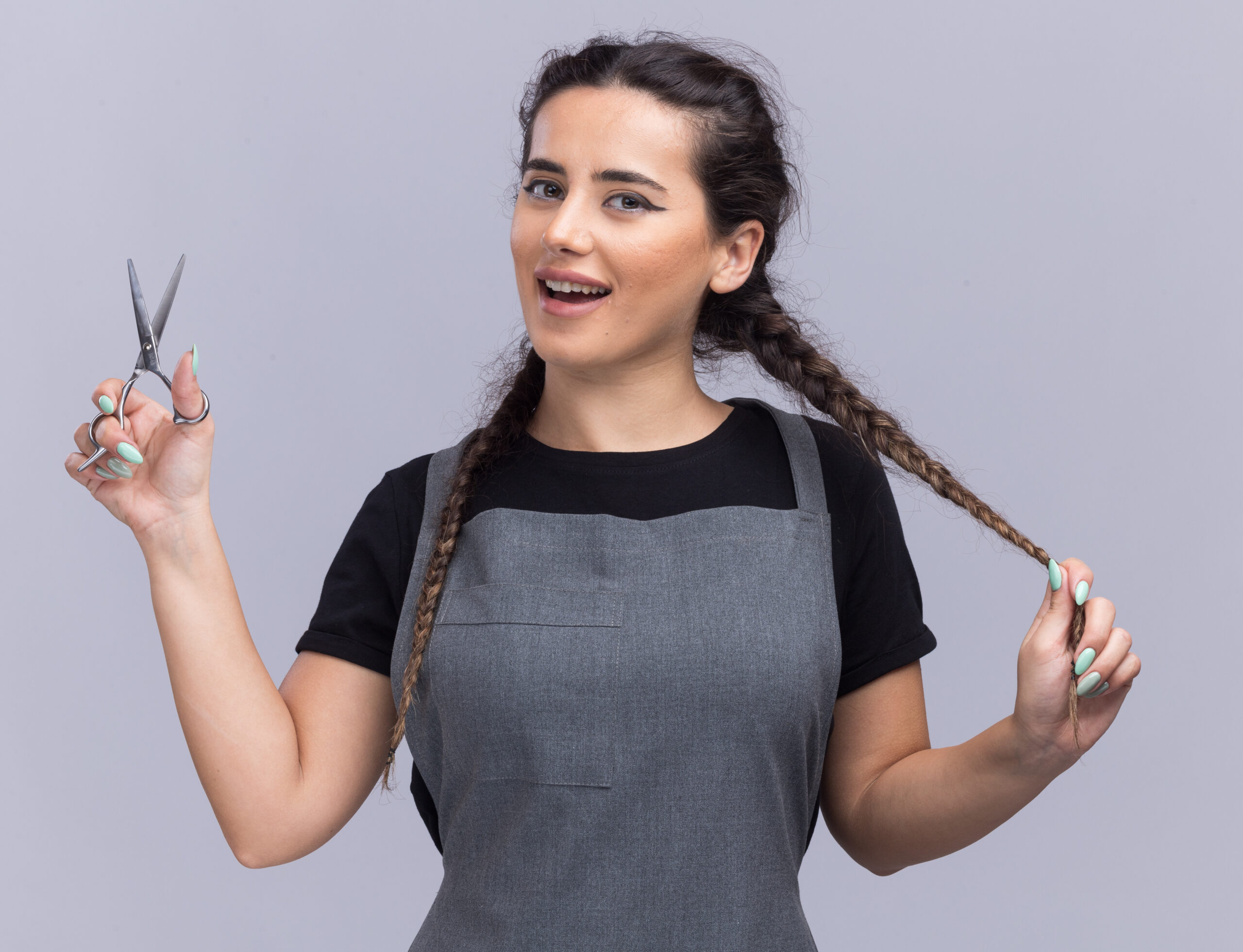 smiling young female barber uniform holding scissors grabbed hair isolated white wall scaled